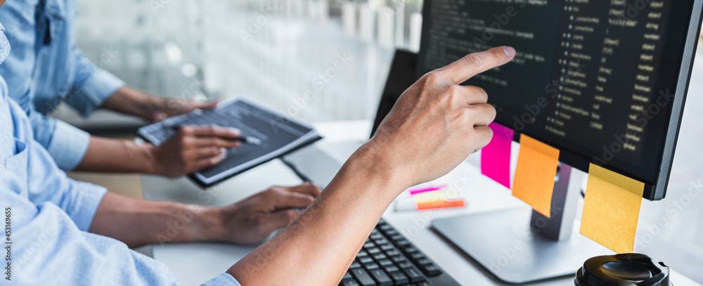 Aufkleber writing codes and typing data code technology, programmer cooperating working on web site project in