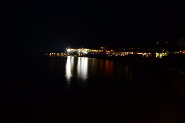 Fototapeta na wymiar lights of the night city on the background of the sea