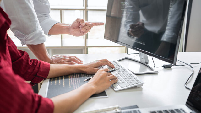 Programmers cooperating at Developing programming and website working in a software develop company office, writing codes and typing data code, Programming with HTML, PHP and javascript