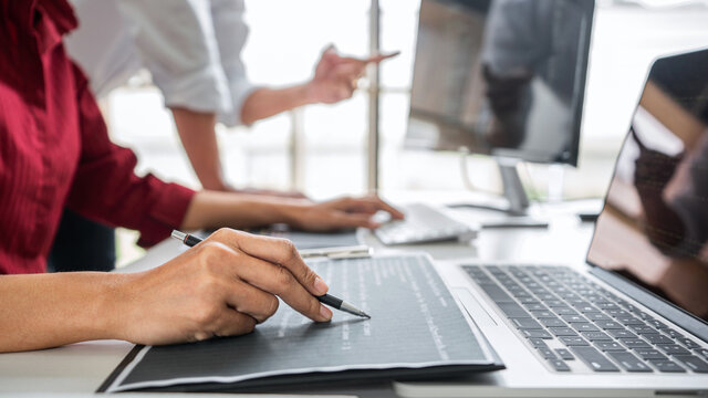 Programmers cooperating at Developing programming and website working in a software develop company office, writing codes and typing data code, Programming with HTML, PHP and javascript