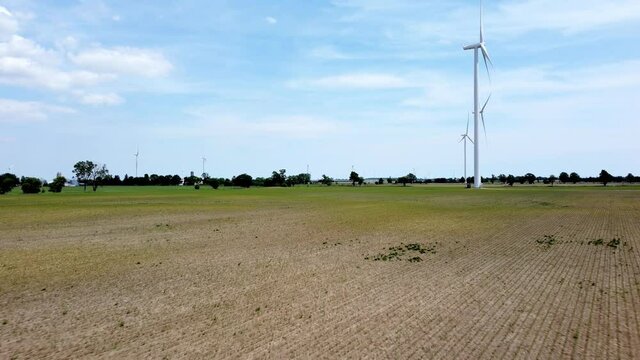 Renewable energy being generated by wind turbines on farmland creating sustainable electricity
