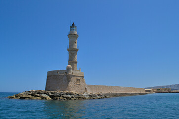 Fototapeta premium Sea lighthouse in summer in sunny cloudless weather.