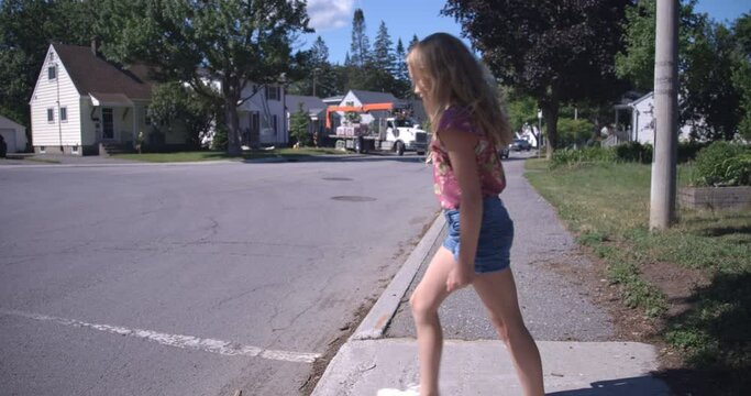 Young girl walking along the streets of her neighborhood