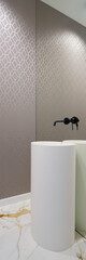 Washbasin with black tap in mirror wall, vertical panorama