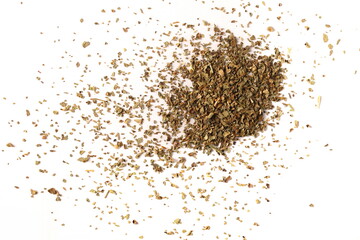Dried and chopped basil spice pile isolated on white background, top view