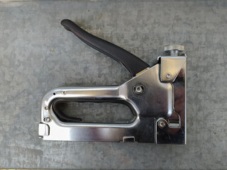 Industrial stapler, on gray background