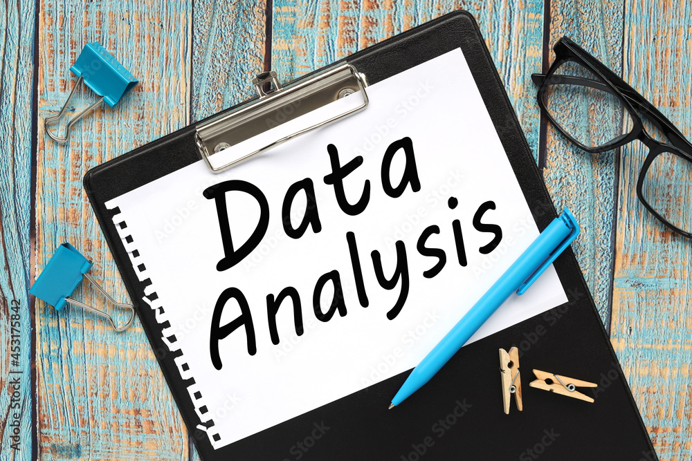 Poster data analysis. text on a notebook sheet. folder on a wooden table in blue