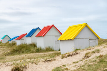 Gouville-sur-Mer, Normandy, colorful wooden beach cabins in the dunes
