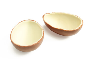 Two halves of milk chocolate egg isolated on white background. 