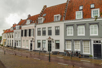 Fototapeta na wymiar Medieval monumental plastered houses near the harbor in Wijk bij Duurstede, Netherlands.