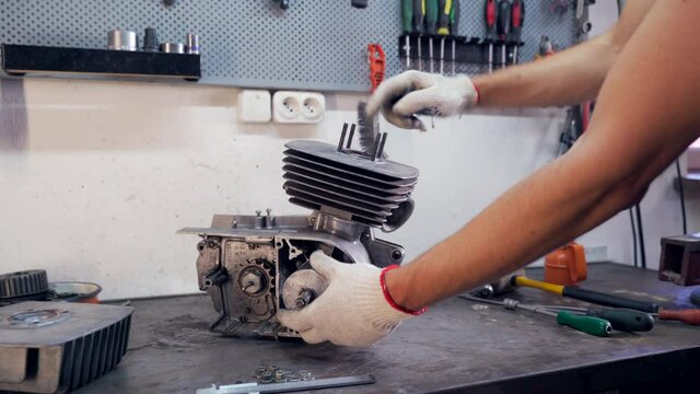 Classic motorcycle engine repair in workshop