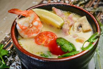 Spicy Tom Yam seafood soup on wooden texture top view