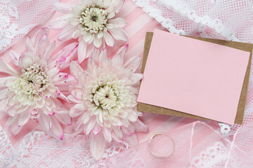 wedding card mockup. bouquet of delicate chrysanthemums, wedding ring and white blank for text