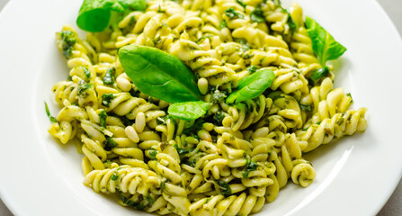 Pesto and pine nut pasta salad, fusilli pasta with regato cheese and baby spinach coated in basil...