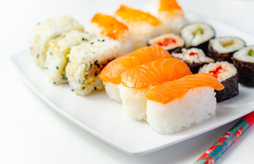 Set of smoked salmon nigiri, Ebi king prawn nigiri, katsu chicken and red pepper California roll, cucumber with wasabi hosomaki roll and red pepper hosomaki roll