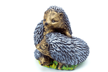 artificial family of hedgehogs concrete garden figure for landscaping and backyard decoration, isolated stone urchin object on white background, nobody.