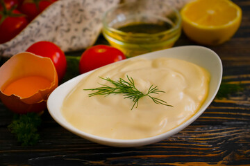 fresh homemade mayonnaise on wooden background