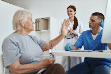 elderly woman in the doctor's office with a nurse discussion service delivery