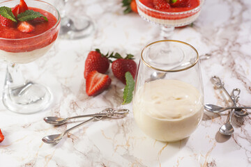 Several glasses with traditional creamy pudding dessert panna cotta with peppermint and strawberry...