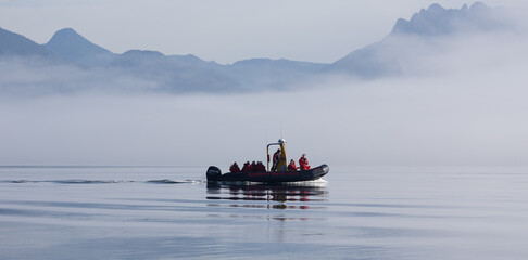 Boat navigates through thick fog, Clayoquot Sound, British Columbia, Canada.