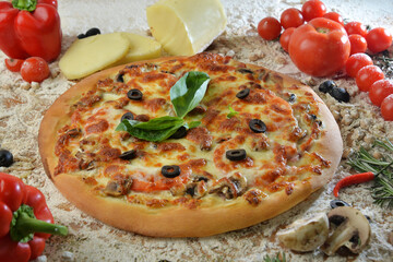 pizza with mushrooms olives and cheese. served on wooden table with ingredients