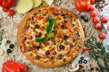 pizza with mushrooms olives and cheese. served on wooden table with ingredients.top view