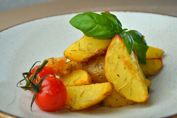Fried potato wedges, herbs on white plate