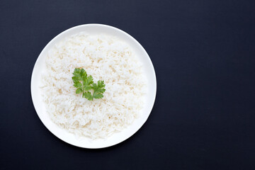 Dish of rice on dark background.