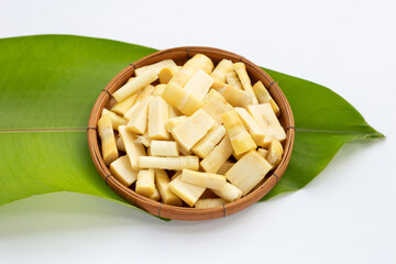 Fresh bamboo shoots in bamboo basket on green leaf