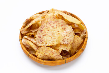 Crispy taro chips in bamboo basket on white background.