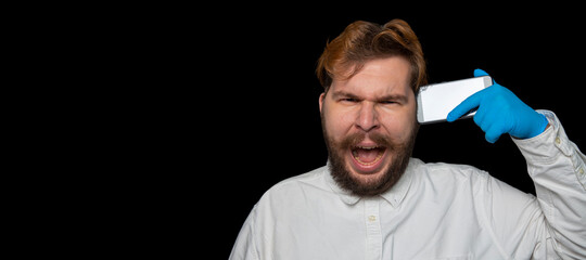 overworking stress emotion portrait of screaming man photography with mobile phone in hand on panoramic black background empty copy space for your advertising text here