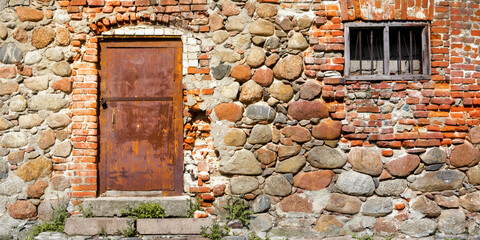 ancient stone wall with door and window