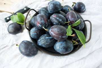 ripe sweet blue plums on a table