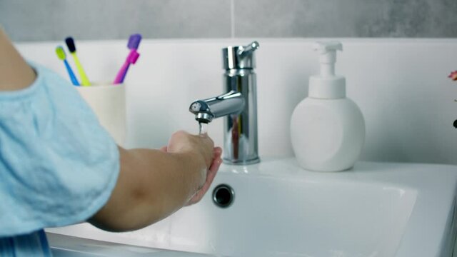 A child washes hands with soap, little girl Hands washing to prevention diffusion of virus and bacteria. Healthcare, Basic home hygiene.