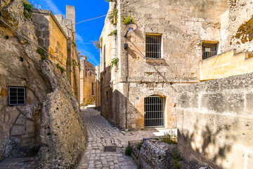 A typical stone back street and narrow alley in the ancient sassi of Matera Italy.