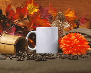 Mug Mock up of one 11 oz white glossy coffee mug on autumn and thanksgiving themed decoration with orange autumn plants and flower, and coffee beans.