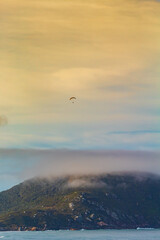 paragliding on the sea, extreme sport, paraglider flying at sunset at Praia dos Ingleses and Santinho, in the city of Florianópolis, Brasil
