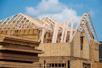 rafters from the wall of a house under construction new