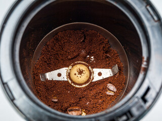 Knife with blades electric coffee grinder for making ground coffee from roasted coffee beans, close-up