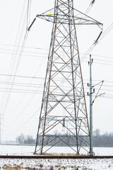 A mast and power lines in a winter landscape