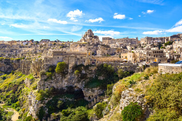 Fototapeta na wymiar The steep cliffs and canyons and the ancient Madonna de Idris rock church in the city of Matera, Italy, in the Basilicata region.