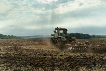 The tractor plows the land. Agriculture image
