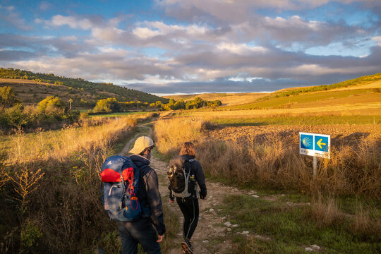 Two Pilgrims Walking at Sunrise on the Way of St James Camino de Santiago Pilgrimage Trail