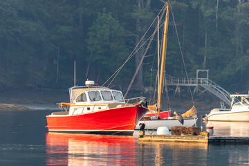 Lobster boats and skiffs on a misty calm morning in Round Pond Maine 