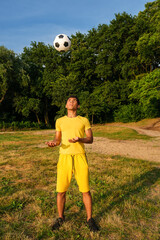Brazilian soccer player trains and improves control of the soccer ball by juggling his head while...