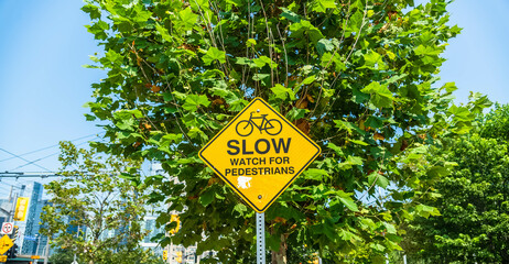 A sign saying slow watch for pedestrians. 