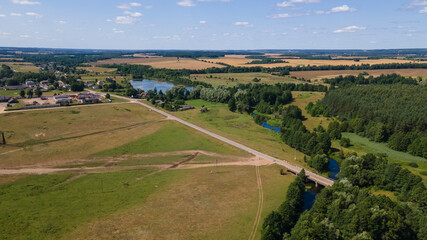 Village among green forest, peace and quiet. The harvest was removed. Countryside background.