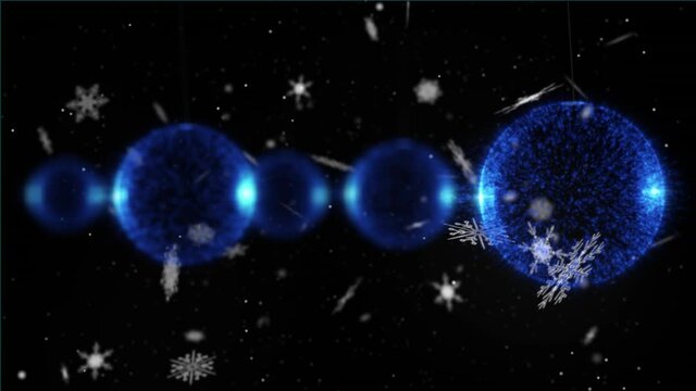 Animation of blue christmas balls over snow falling on dark background