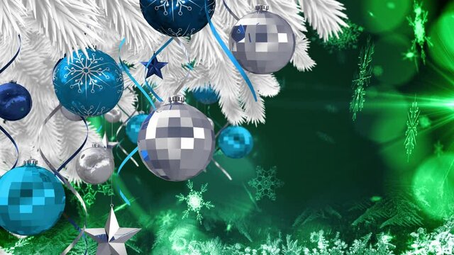 Animation of christmas boubles over green background with snow falling