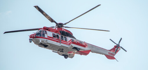Ambulance, military or civilian helicopter on sky background.